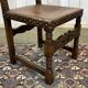 High-backed chair from the early 20th century in oak and leather