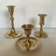 Trio of brass candle holders