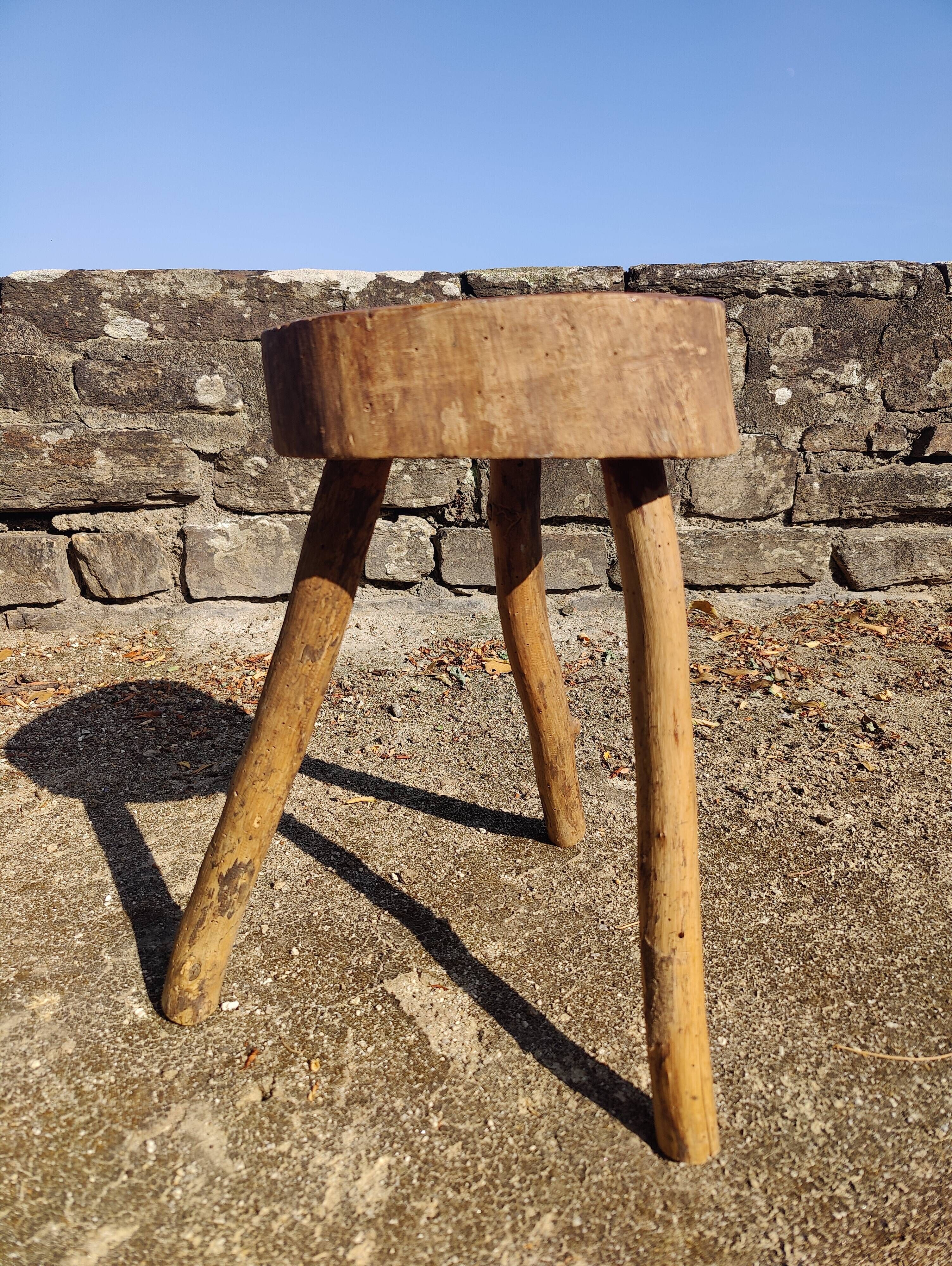 Rustic three-legged stool in minimalist wood in the style of Touret.