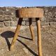 Rustic three-legged stool in minimalist wood in the style of Touret.