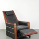 Electrically adjustable Art Deco design recliner with black cowhide leather