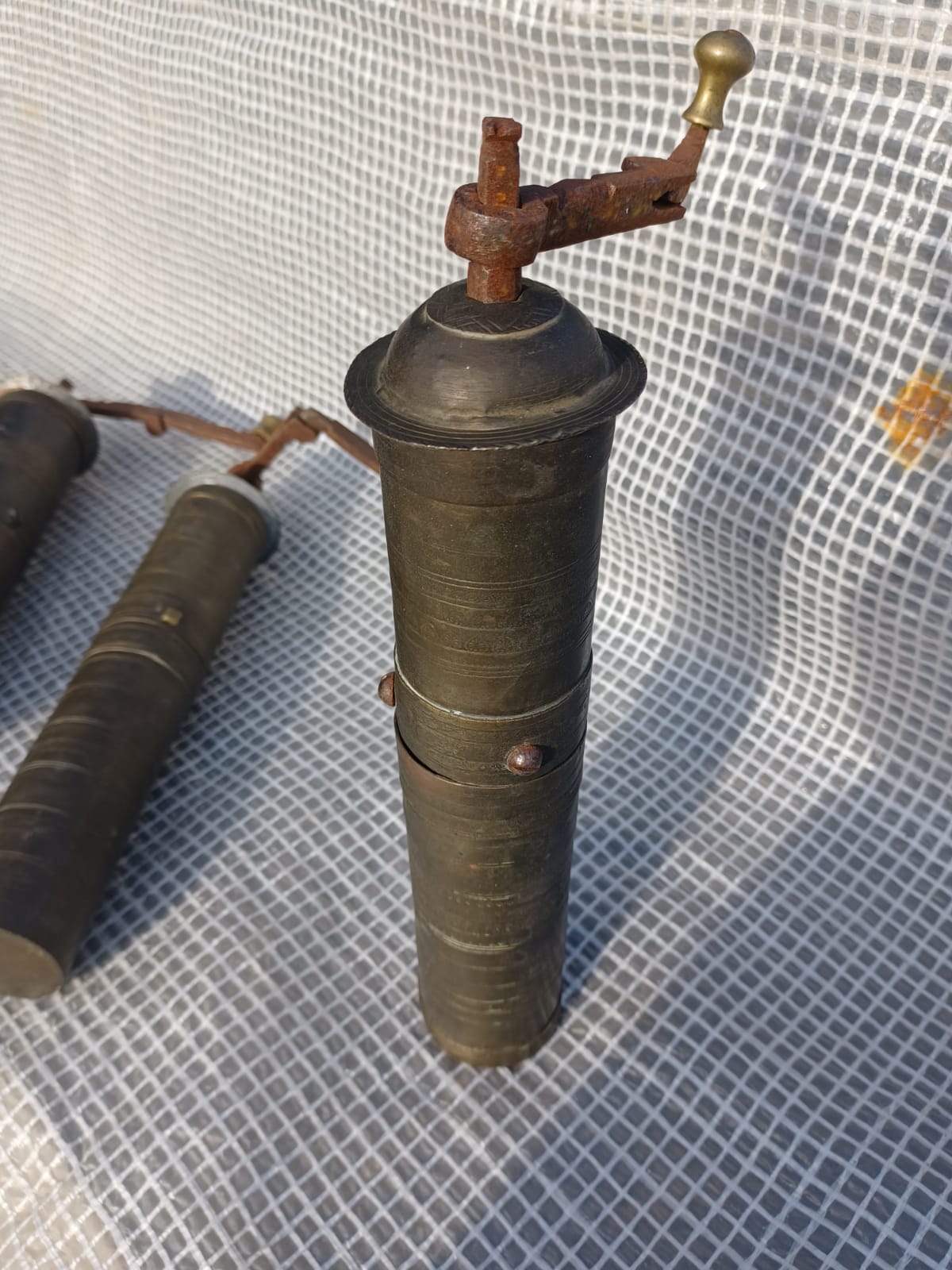 Three oriental brass and iron pepper mills XIX century