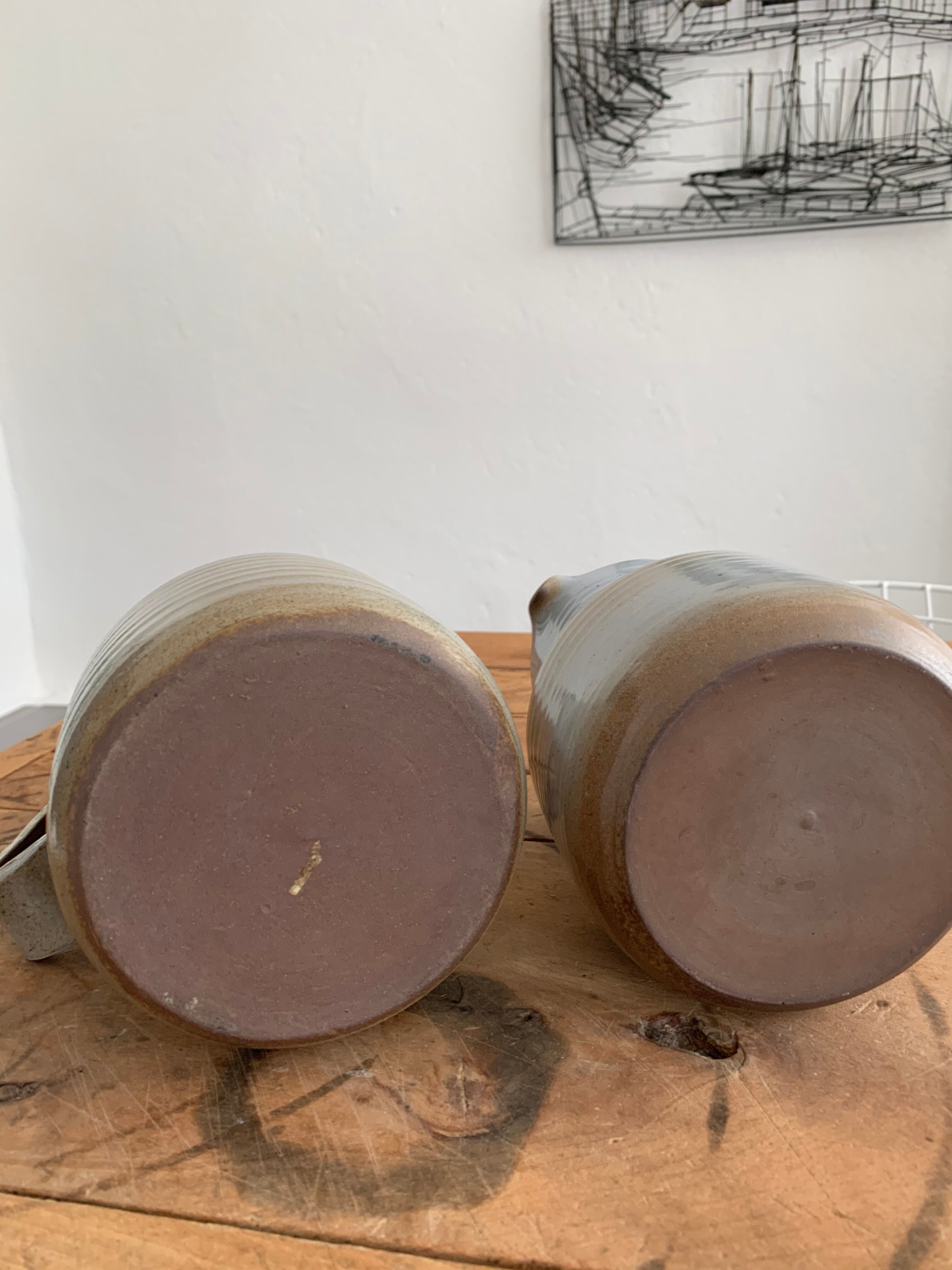 Pair vintage enamelled ceramic pitchers