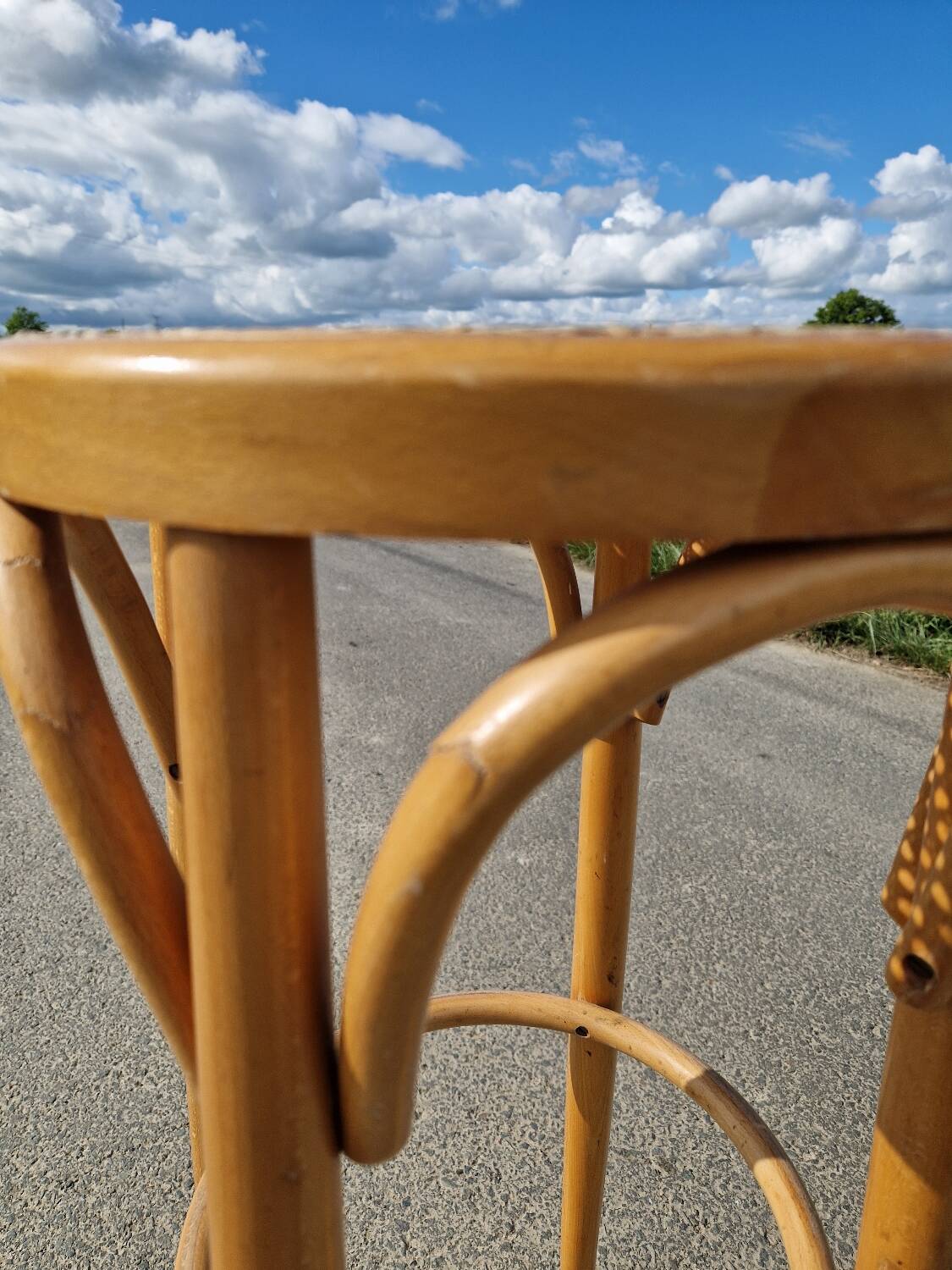 High bar stool in curved wood and cane