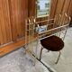 Hairdresser and vintage stool in gilded brass and mirror — brown seat, straw yellow accents.