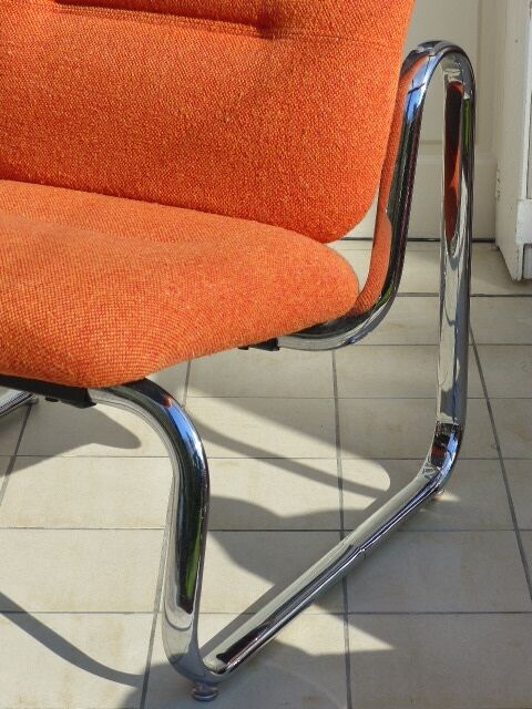 The 1970s orange armchair fabric and chrome metal