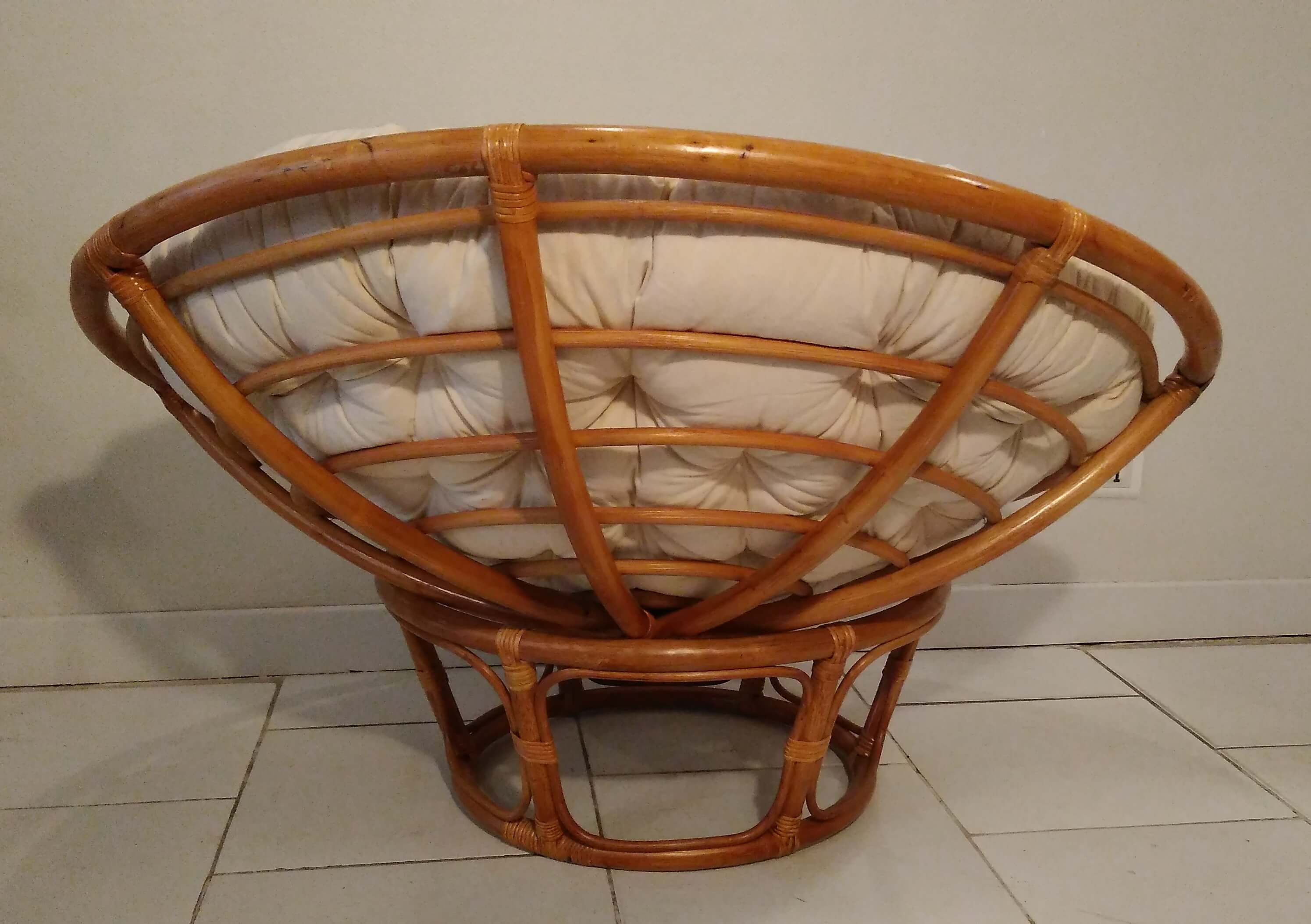 Rattan swivel chair and linen cushion