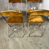 Four folding velvet and brass chairs
