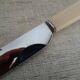 12 vintage stainless steel knives bone or bakelite sleeves in case