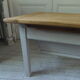 Coffee table made from an authentic farmhouse table, leg patinated pearl gray