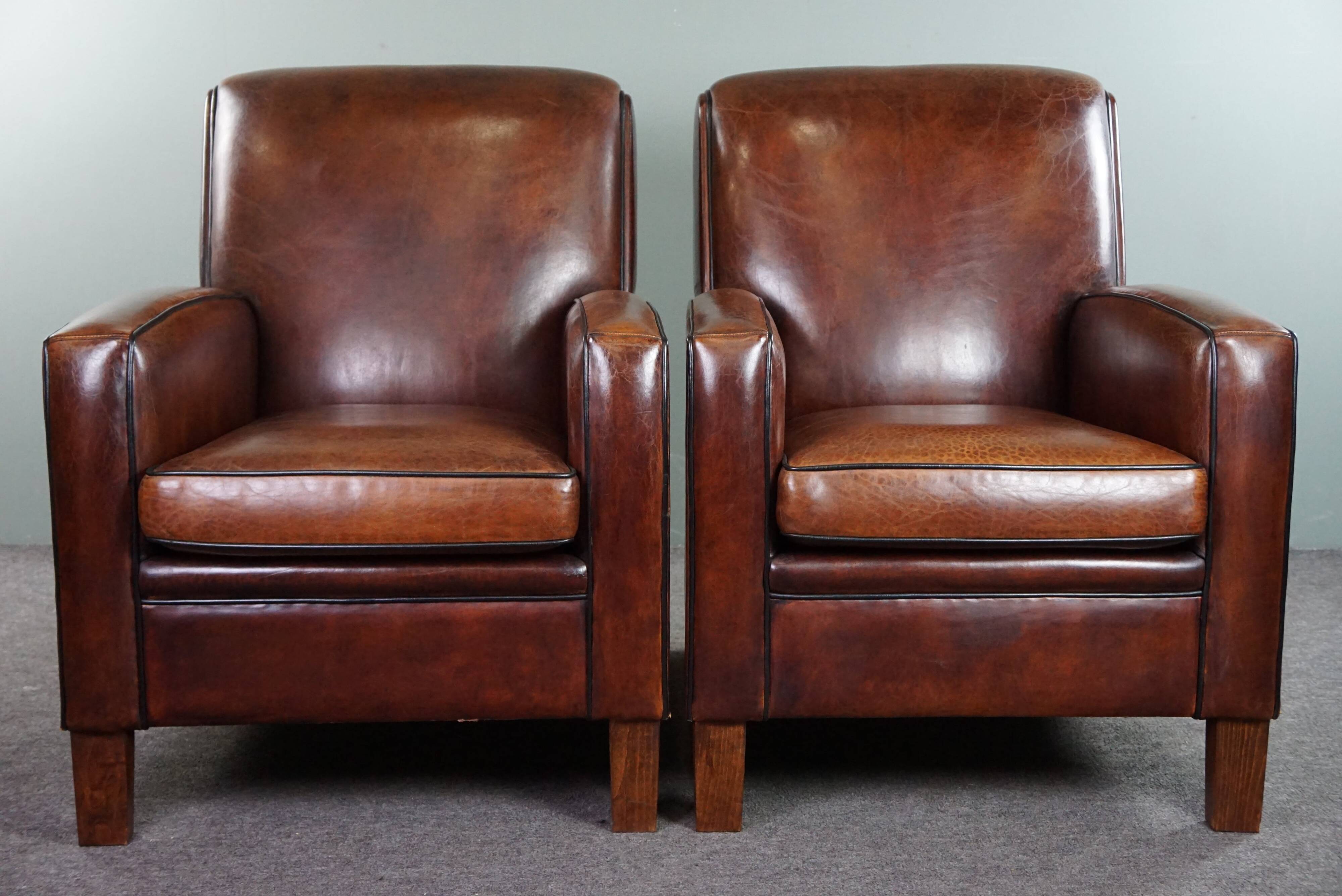 A very beautiful set of 2 Art Deco design armchairs in sheep leather