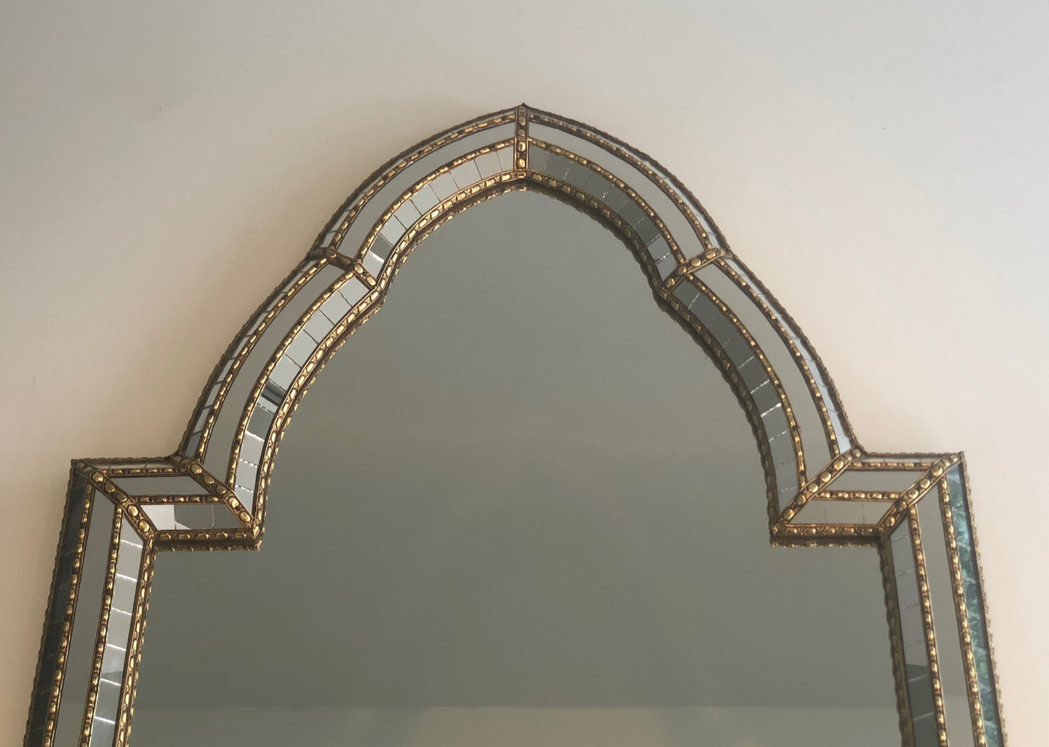 Multi-faceted mirror and brass garlands