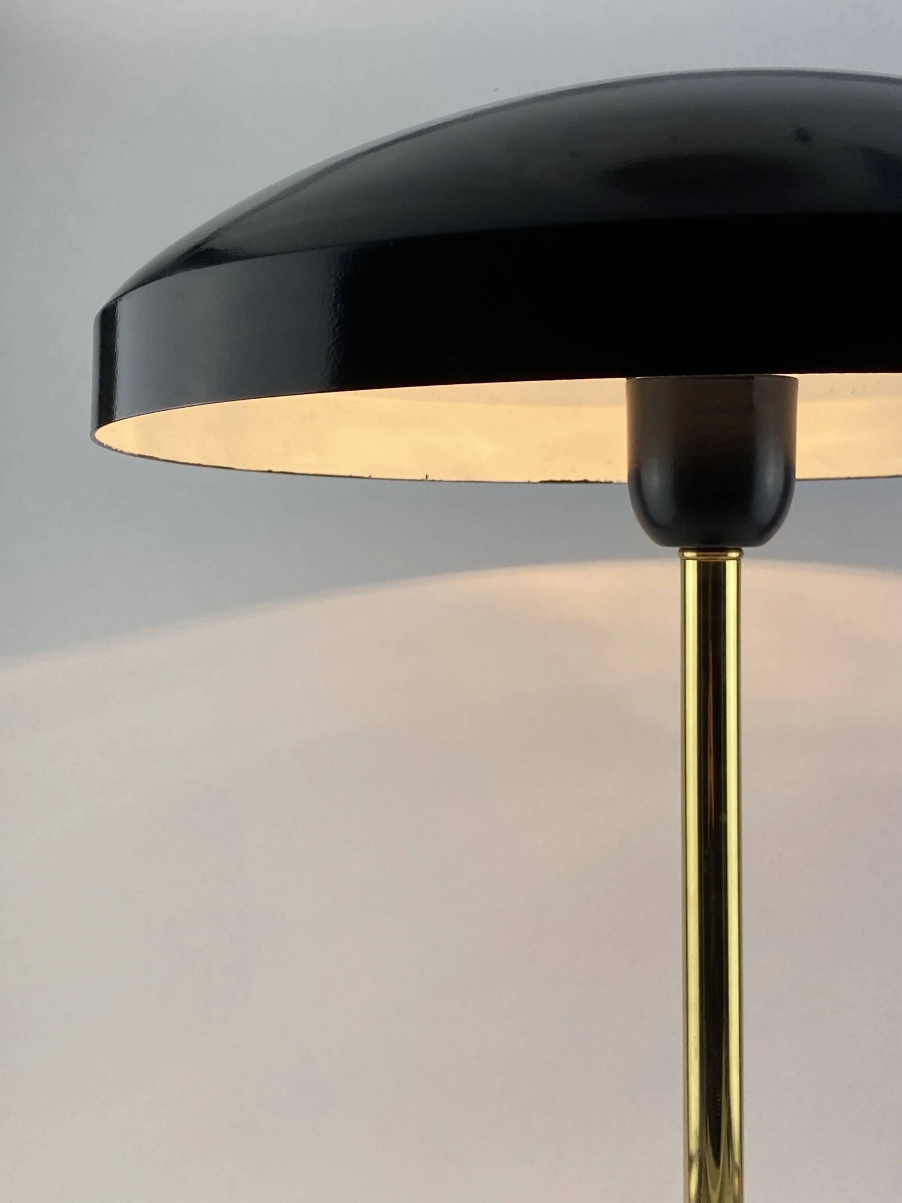 Rare black and gold UFO table lamp by Louis Kalff for Philips.