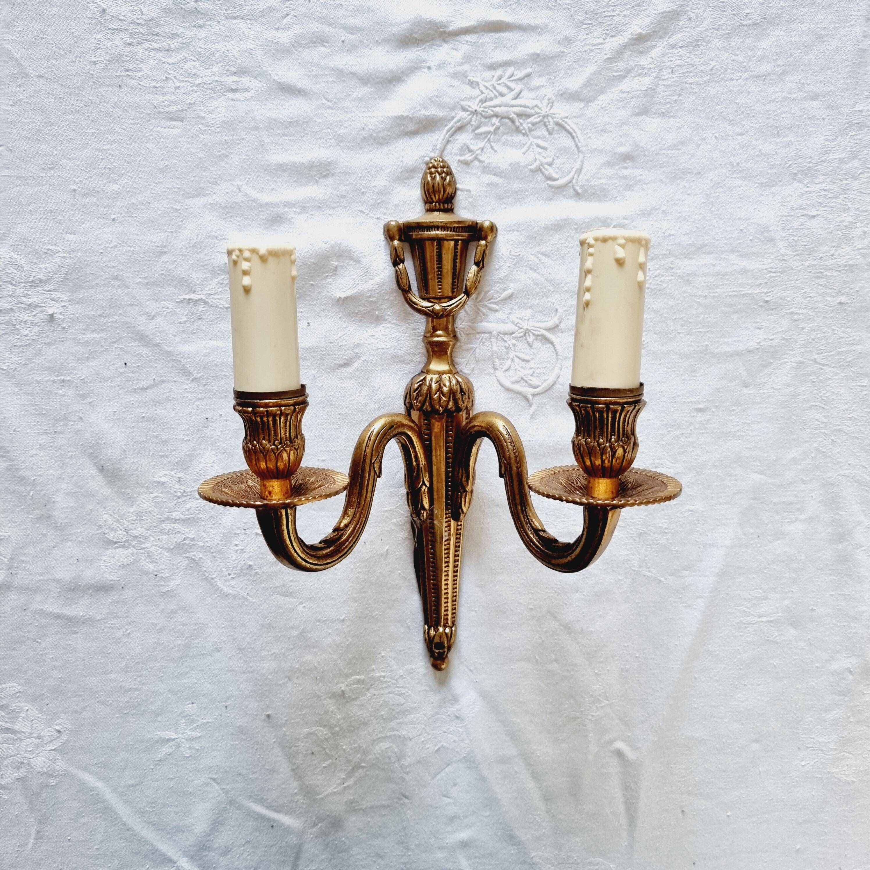 French Empire-style wall sconce or chandelier in bronze with an antique gold patina.
