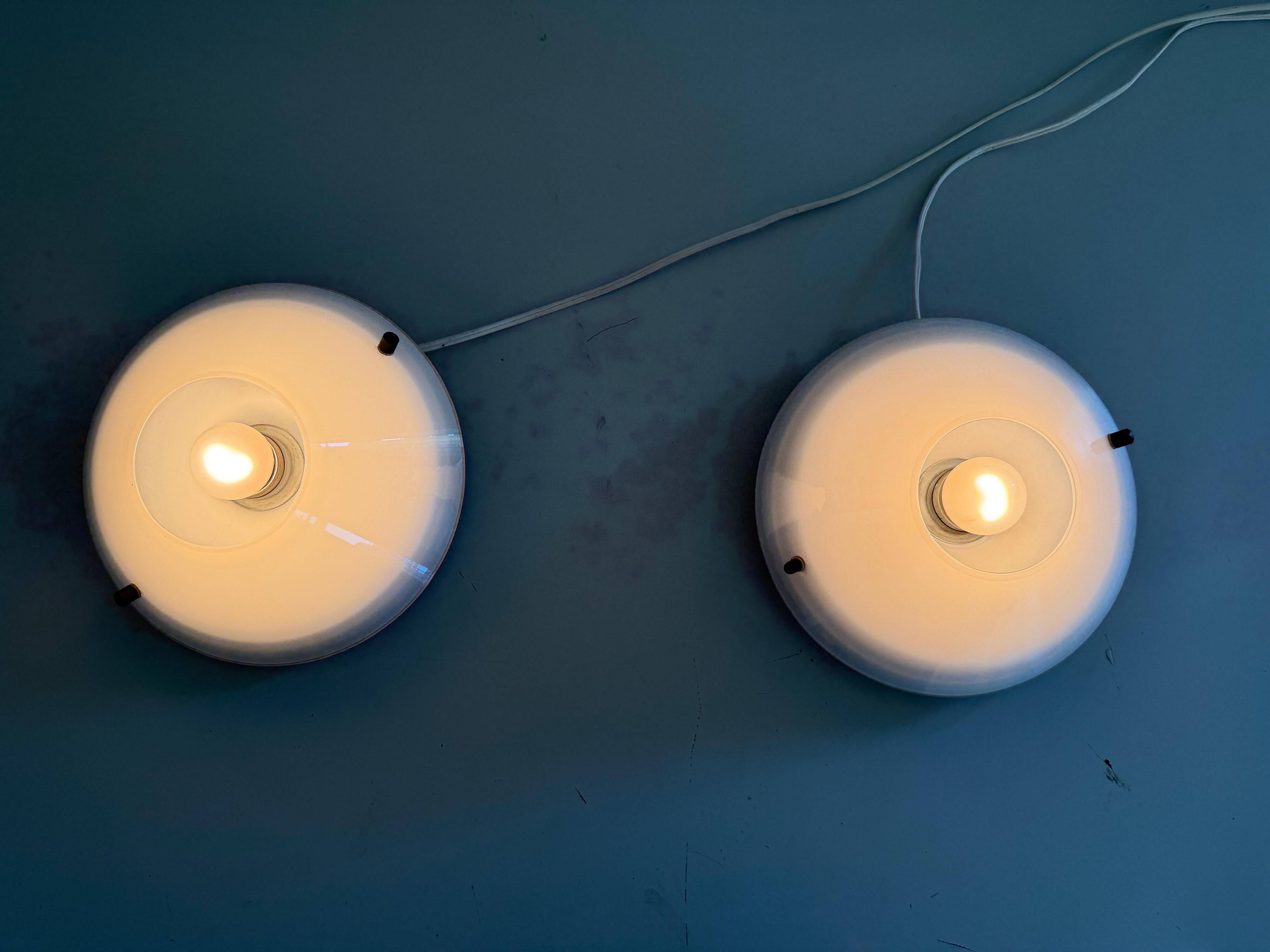 Pair of opal glass wall lights from the mid-century by Lamperti, 1960s, Italy.