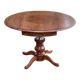 Round dining table, solid wood, central leg, extendable flaps, 20th century.