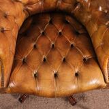 Office chair known as a presidential chair in mahogany and cognac leather.