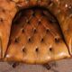 Office chair known as a presidential chair in mahogany and cognac leather.