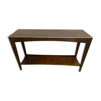 Mahogany console with a golden border.