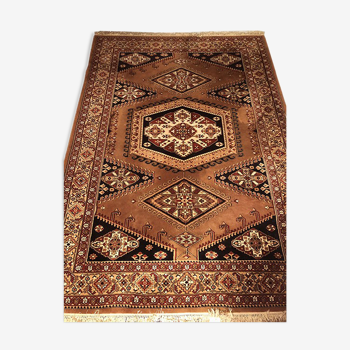 Wool carpet with oriental decoration on a brown background