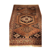 Wool carpet with oriental decoration on a brown background