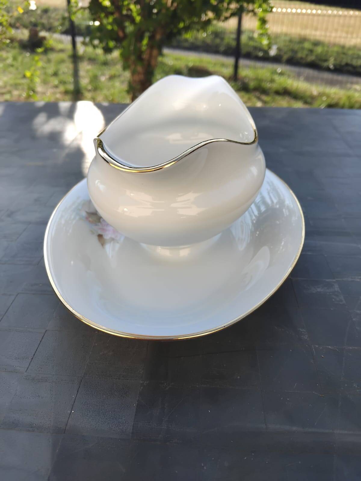Vintage fine porcelain sauce boat with gold gilding.