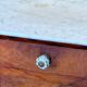 Wood and marble side table with ceramic handles.