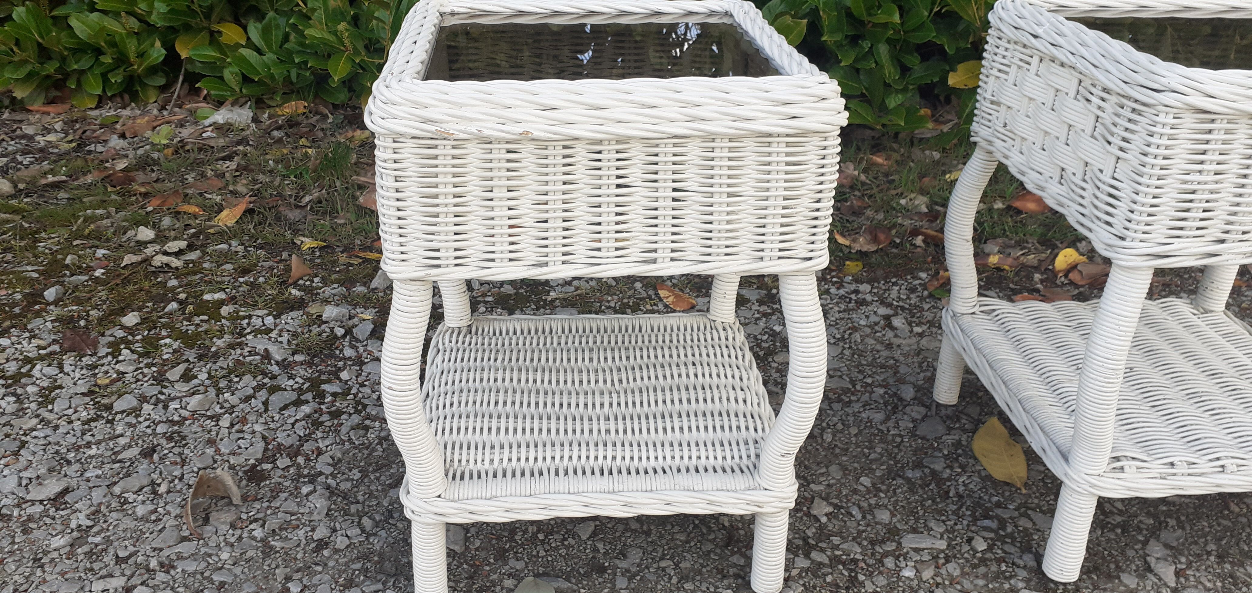 Pairs of white rattan side tables and smoked glass
