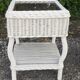 Pairs of white rattan side tables and smoked glass