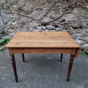Vintage pine table with drop-leaf extension and turned beech legs, France, 1930s.