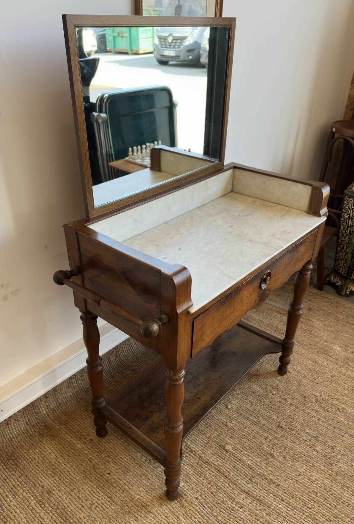 Antique bathroom cabinet with white marble and mirror.