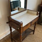 Antique bathroom cabinet with white marble and mirror.