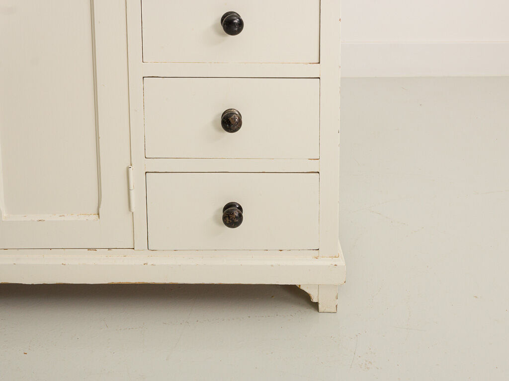 Small accent cabinet with drawers and swing doors