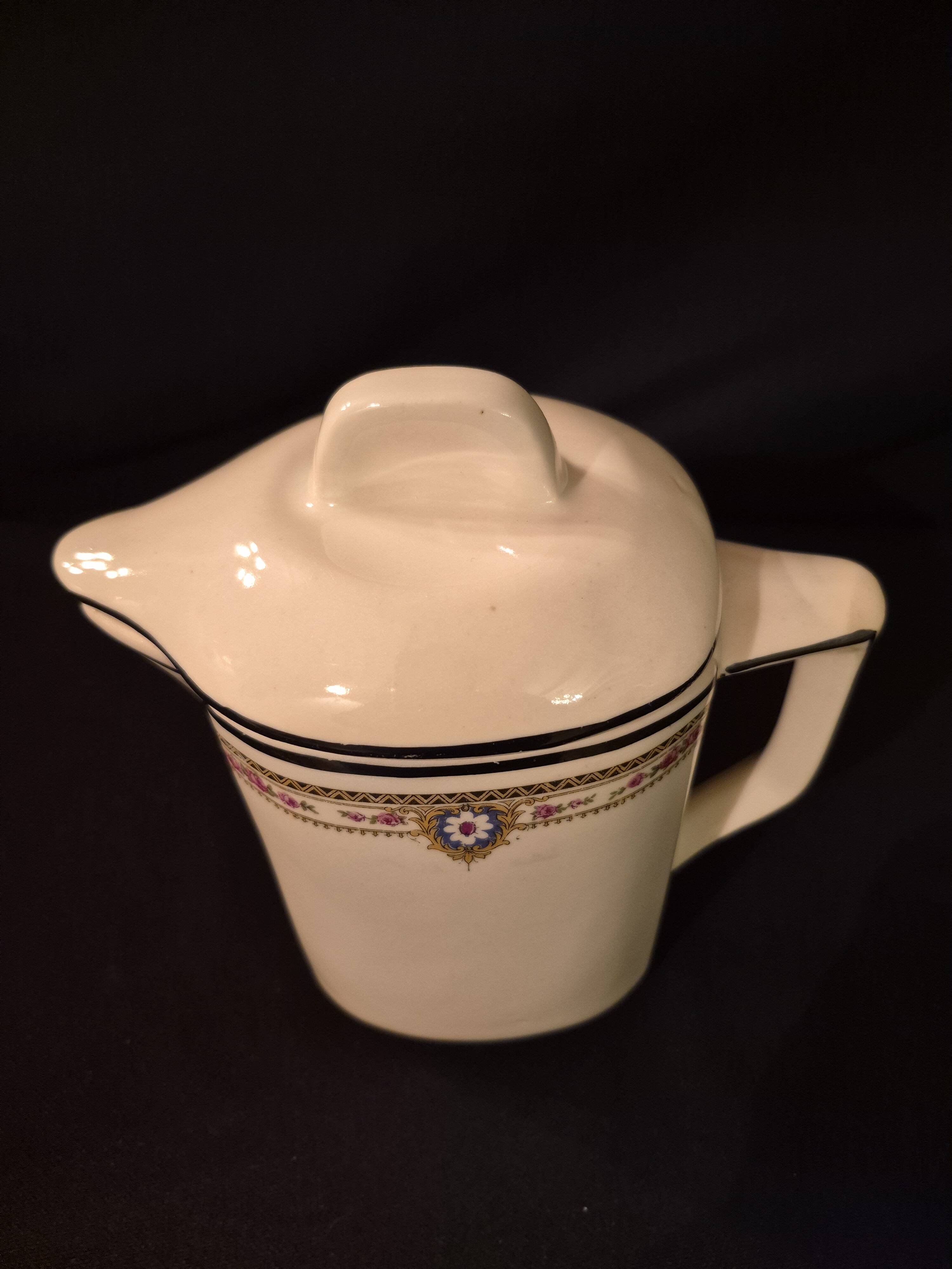 Old covered jug, vintage, geometric frieze with flowers and black trim.