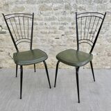Black metal chairs with khaki faux leather seats, circa 1960.