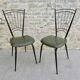 Black metal chairs with khaki faux leather seats, circa 1960.