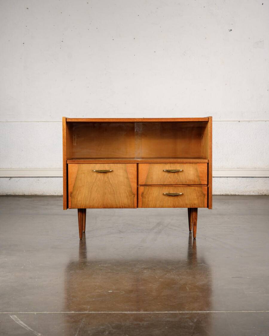 Old TV cabinet with brass handles.