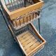 Woven rattan and steel display shelf in the shape of a staircase.