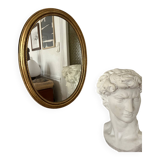 Oval mirror in antique gilded wood