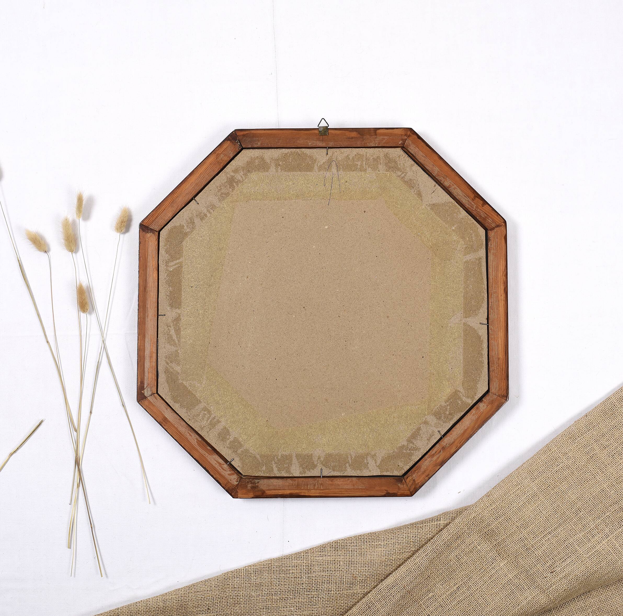 Old second-hand wooden mirror, octagonal shape.