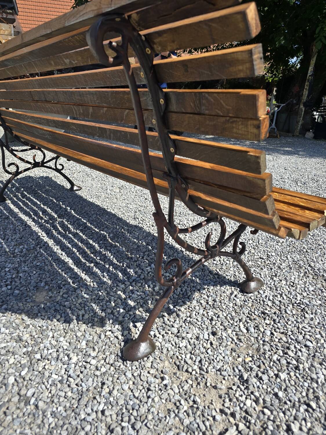 Wooden garden bench with cast iron base