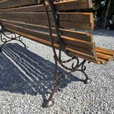 Wooden garden bench with cast iron base