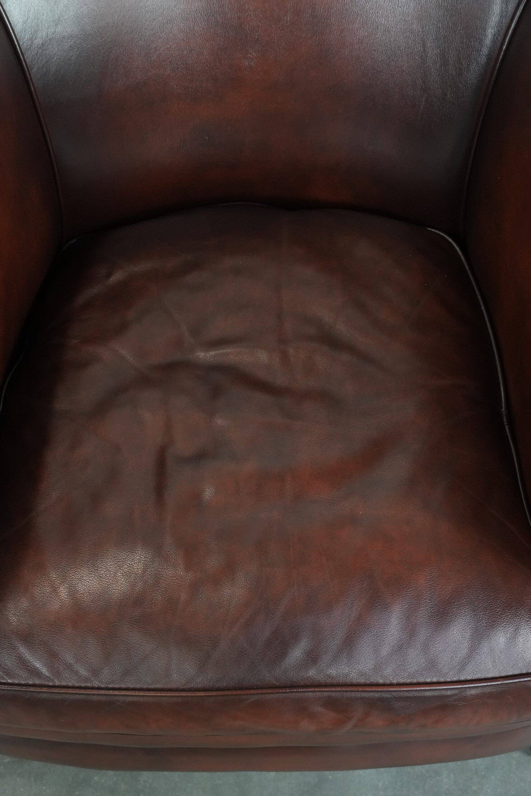 Set of two cow leather club armchairs in a luxurious red/brown colour