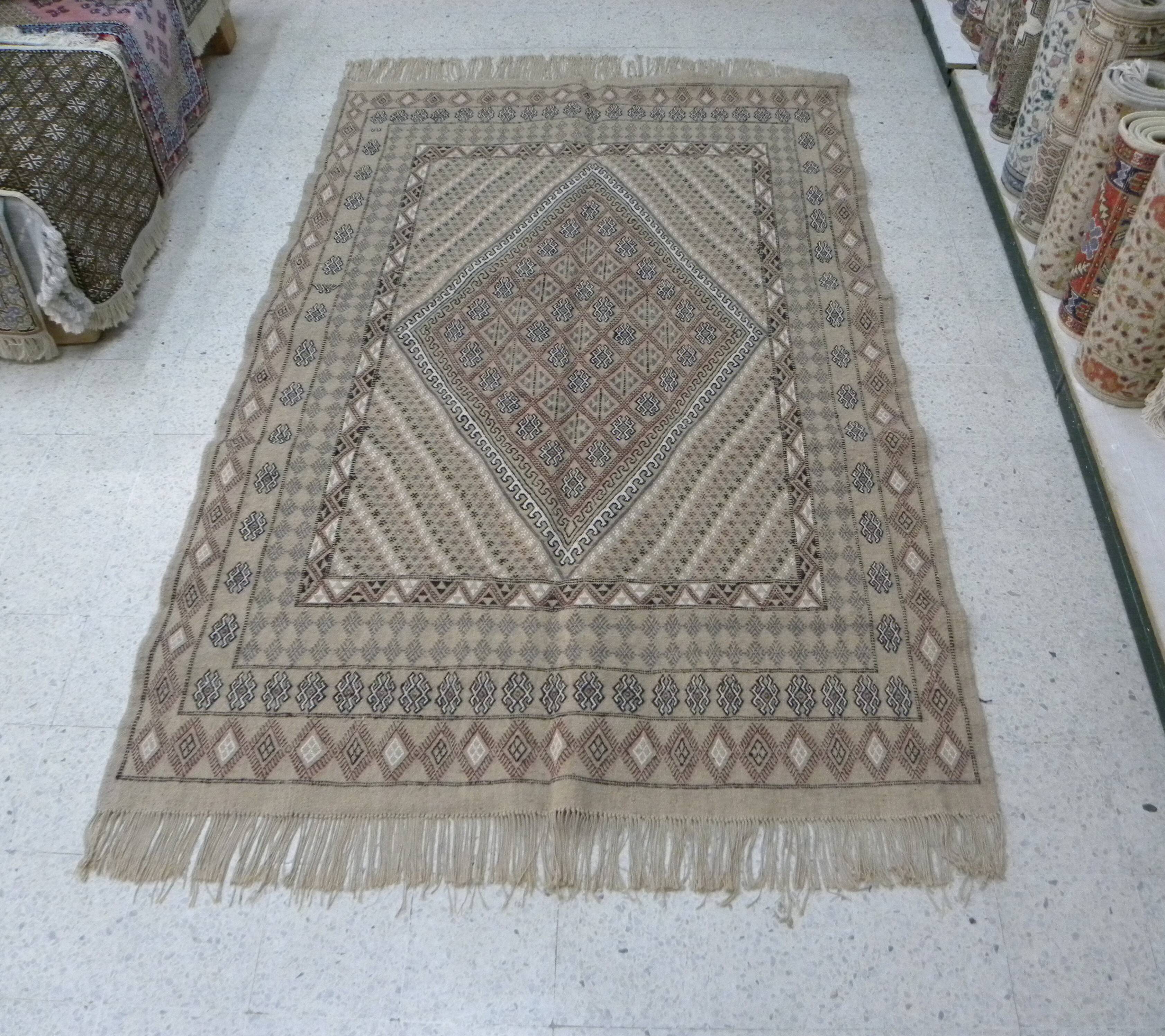 Traditional handmade Berber carpet in brown and beige wool.