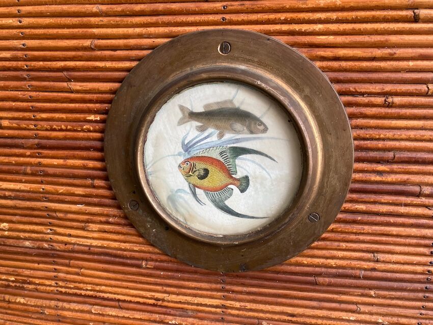 Rattan and wood bar with its decorative brass portholes
