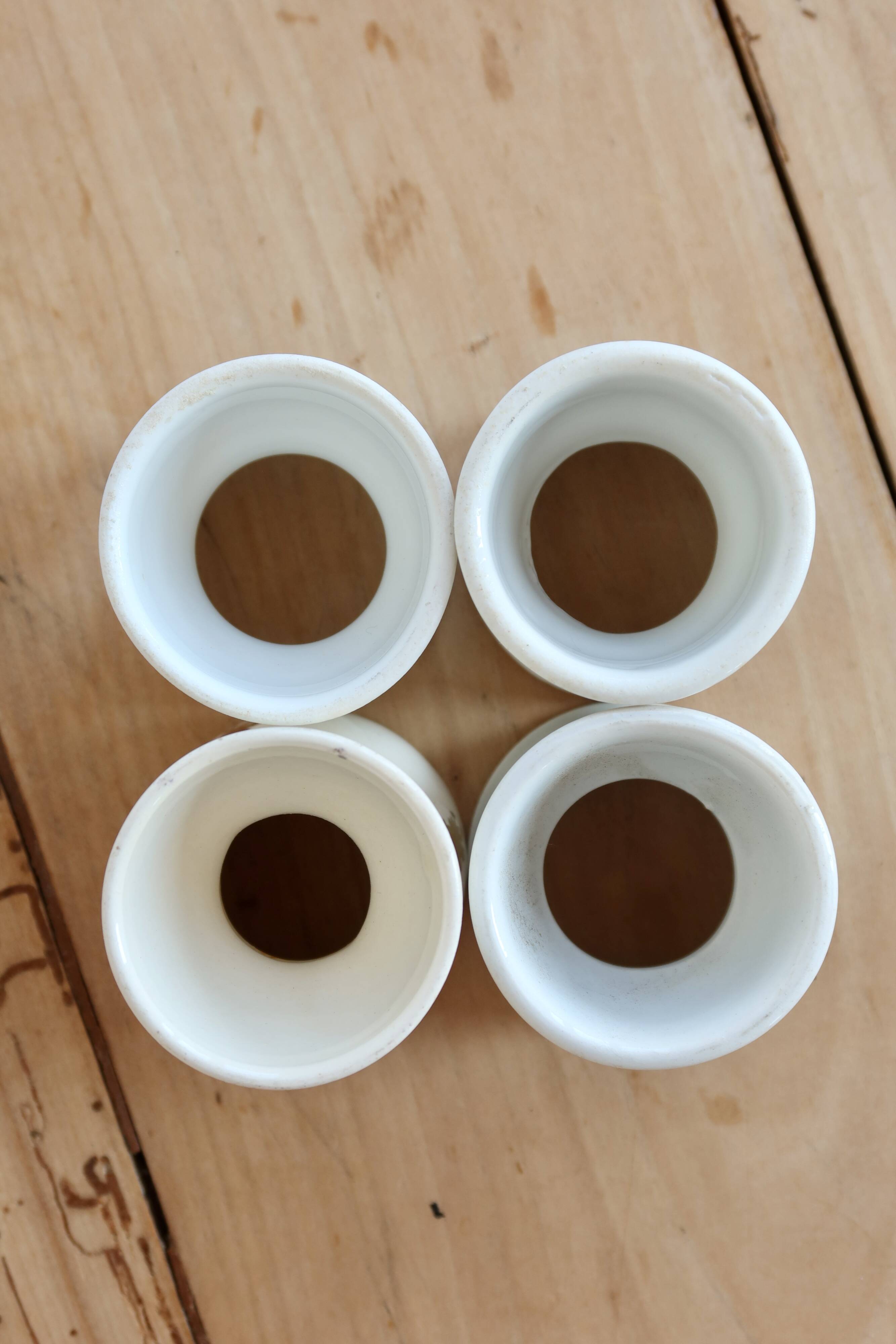 4 mismatched vintage diabolo egg cups in earthenware