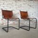 pair of tubular chairs in tawny leather