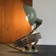 Old extendable accordion lamp in celadon green, workshop spirit.