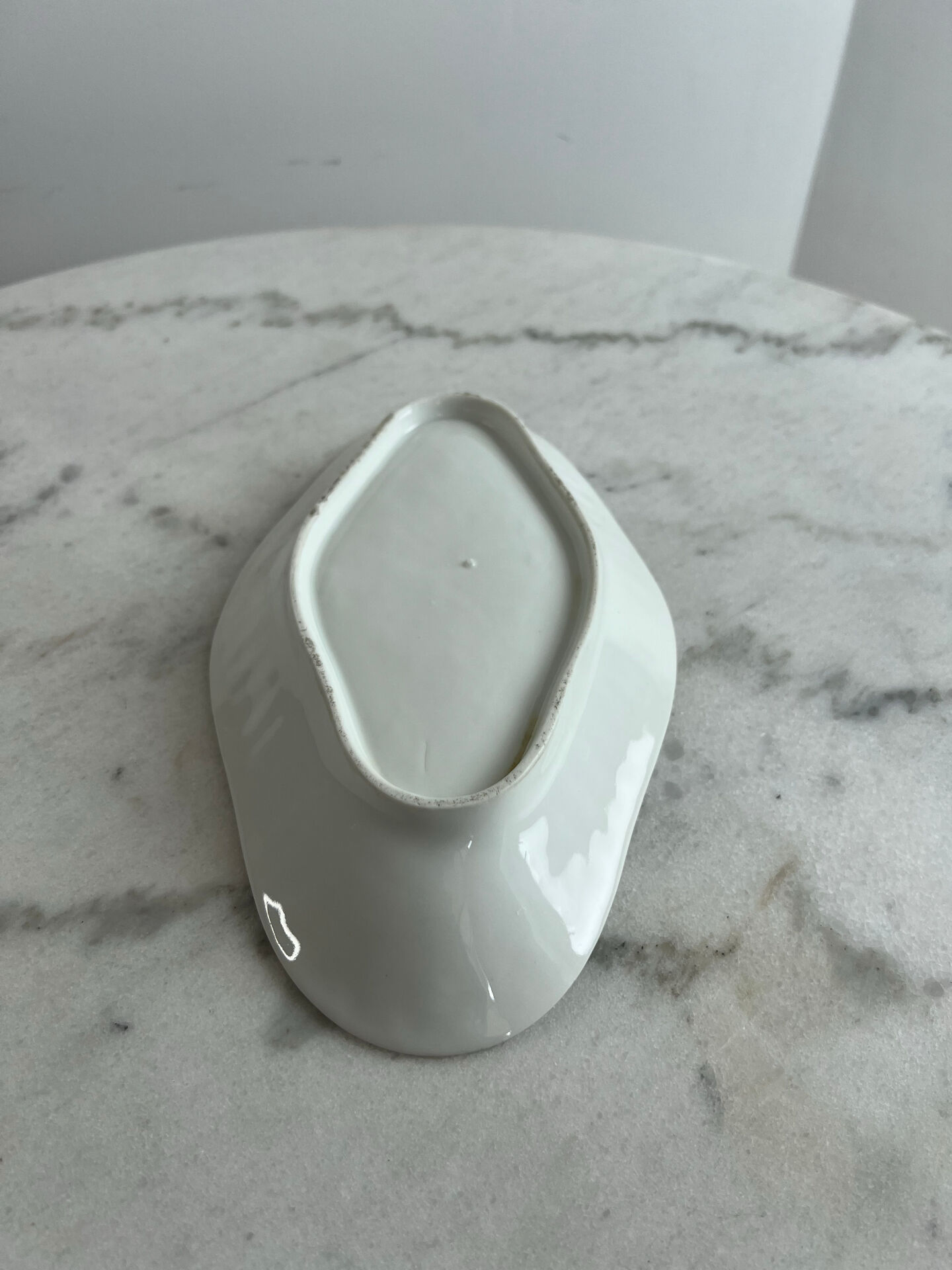 Oval white porcelain ramekin — raised floral pattern