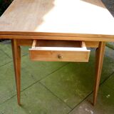 wooden dining table with compass legs and extensions